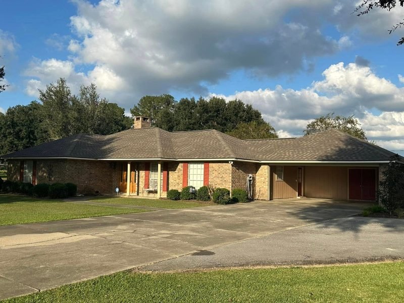 Brick ranch home with a new tan shingle roof and an attached garage